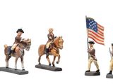 several figurines of men riding horses with a flag on top of them
