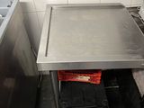 a small table in the middle of a kitchen