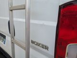 a white truck with a ladder attached to the back of it