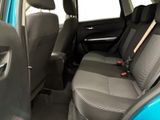 the back seats of a blue car with black trims and a red seat belt