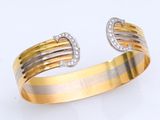 une photo d'un bracelet manchette en or et en argent serti de diamants