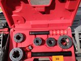 a red tool box with tools in it on the ground
