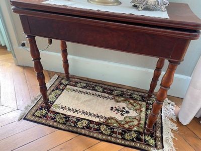 a small table with a mirror on top of it