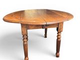 an oval oak dining table with turned legs