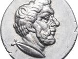 a close up of a coin with a man ' s face on it