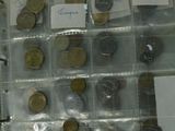 a lot of coins in a clear case with notes on them