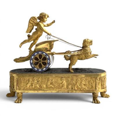 une figurine en or représentant un ange tirant une charrette avec un chien
