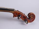 a close up of a violin on a white surface