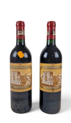 two bottles of red wine sitting next to each other on a white surface