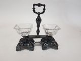 a black candle holder with two glasses on top of it