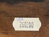 an image of a close up of a piece of wood with a label on it