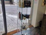 a glass display case with a lot of bottles in it