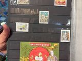a person holding a book with a bunch of stamps on it