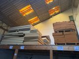 several stacks of cardboard boxes are stacked on a pallet in a warehouse