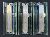 three pieces of glass that are on a black surface