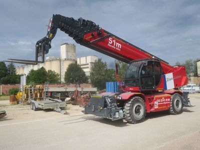 a red crane that is sitting on the side of the road