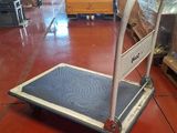 a dolly that is sitting on the floor in a warehouse
