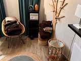 a living room with two chairs and a rug on the floor