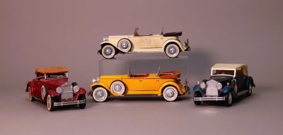 several toy cars are stacked on top of each other on a table