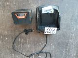 two batteries and a charger sitting on the floor