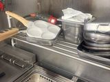 pots and pans are on the stove in a commercial kitchen