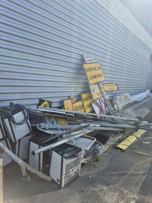 a pile of junk on the ground next to a building