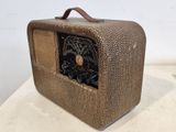 an old fashioned radio sitting on top of a white table