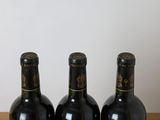 three bottles of wine sitting on a table next to each other