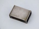 a small metal object on a white surface