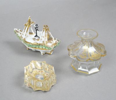 three pieces of glass on a table with a boat on top of it