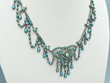 a necklace with turquoise beads on a white mannequin