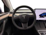 the interior of a car with a steering wheel, dashboard, and monitor