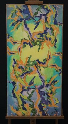 abstract painting on easel with easel and black background