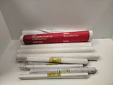 a lot of rolls of white paper sitting on a table