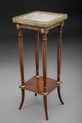 a small table with a marble top and wooden legs