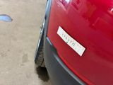 a red car with a sticker on the side of it