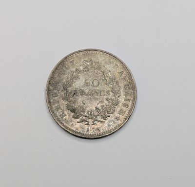 a close up of a coin on a white surface