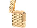 lighter made of gold plated metal on a white background