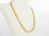 a gold chain necklace on a mannequin torso