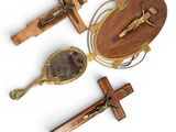 three wooden crucifts and a wooden spoon on a white background