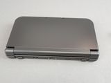 a silver laptop sitting on a table with a white background