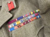 a suit jacket with a tie and a medal on it