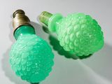 two green lights that are on top of a white table