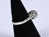an image of a diamond ring on a black ring holder