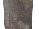 an old wooden block with a black base on a white background