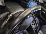 a steering wheel in a car with a cell phone in it