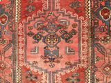 a red and blue rug with a design on it