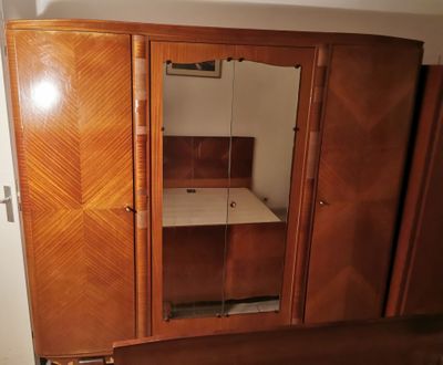 a wooden cabinet with a mirror on it in a room