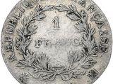 an old silver coin with a wreath on it