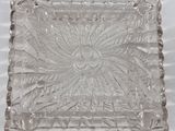 rectangular clear glass tray with a flower design on the edge